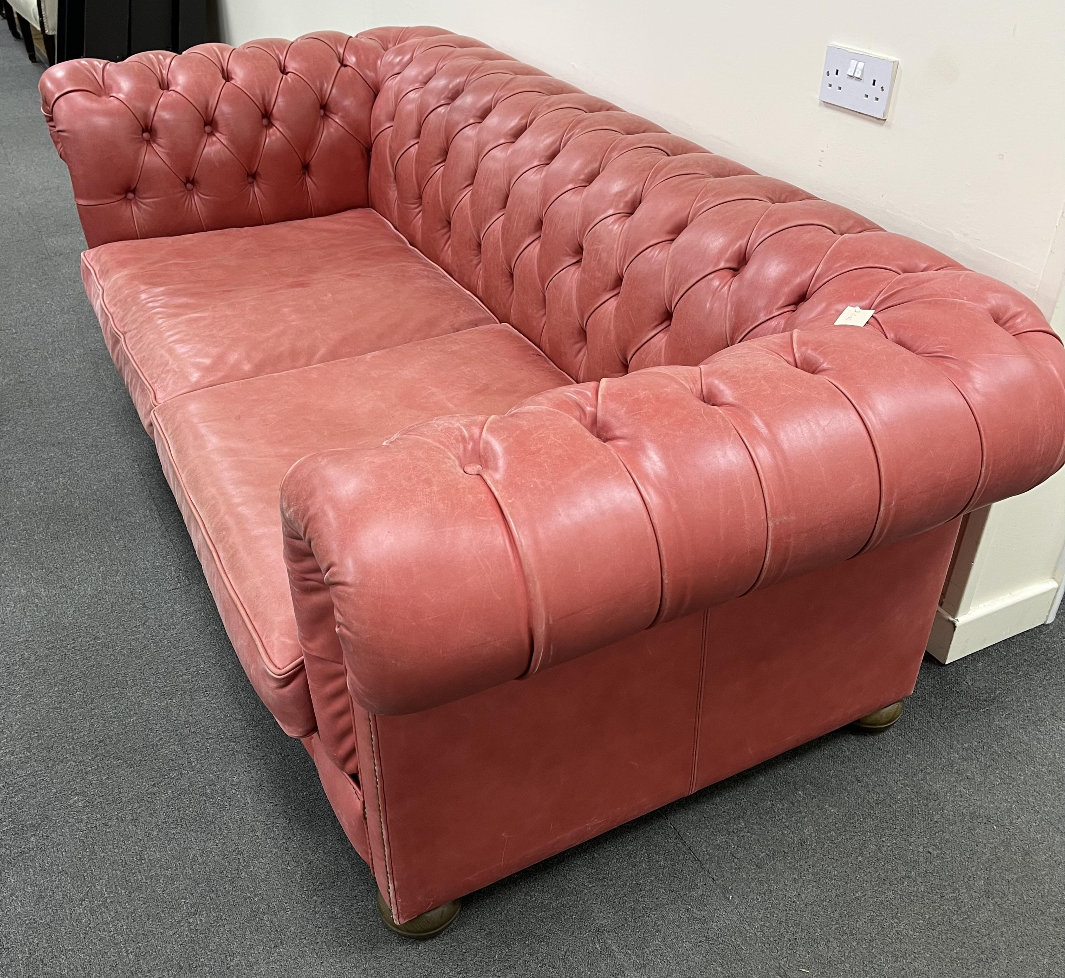 A Victorian style buttoned pale red leather Chesterfield settee, width 210cm, depth 104cm, height 71cm. Condition - fair to good